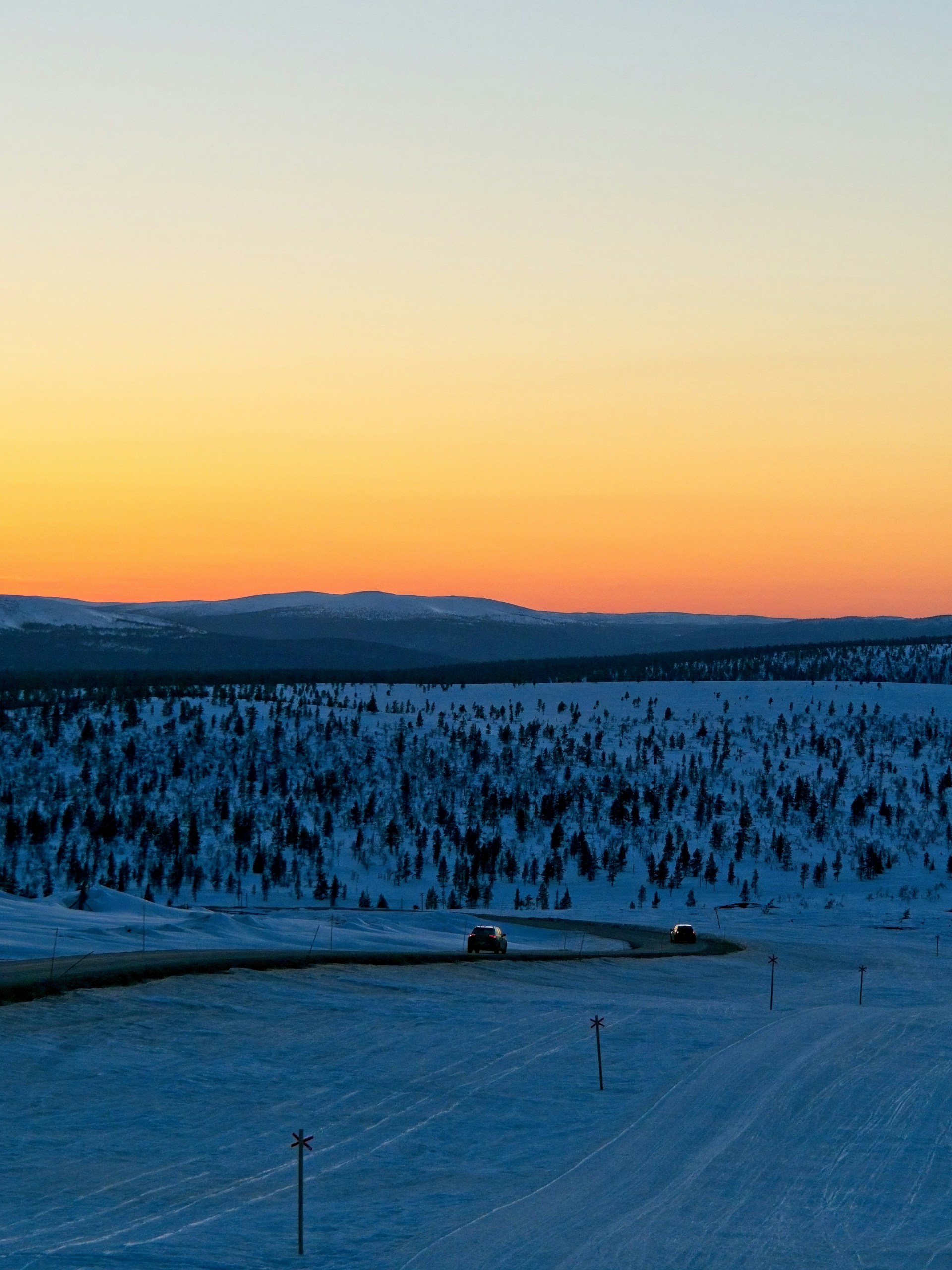 Sunset at Kaunispää, Finland. Cars driving down the fell after the sun has set. Photo by Jarkko Kemppainen